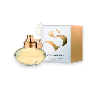 Frasco de Shakira S EDT con sus formas curvas y un líquido dorado que refleja una luz cálida.